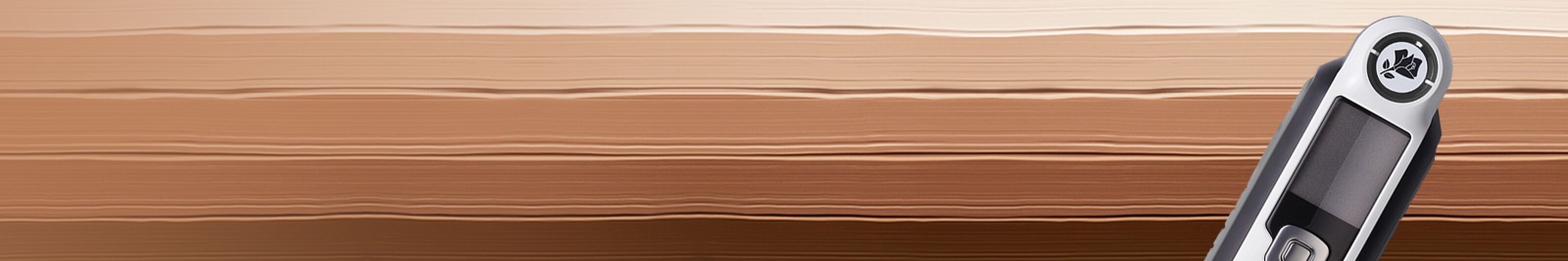 A sleek digital thermometer on a smooth, gradient background featuring warm bronze tones.