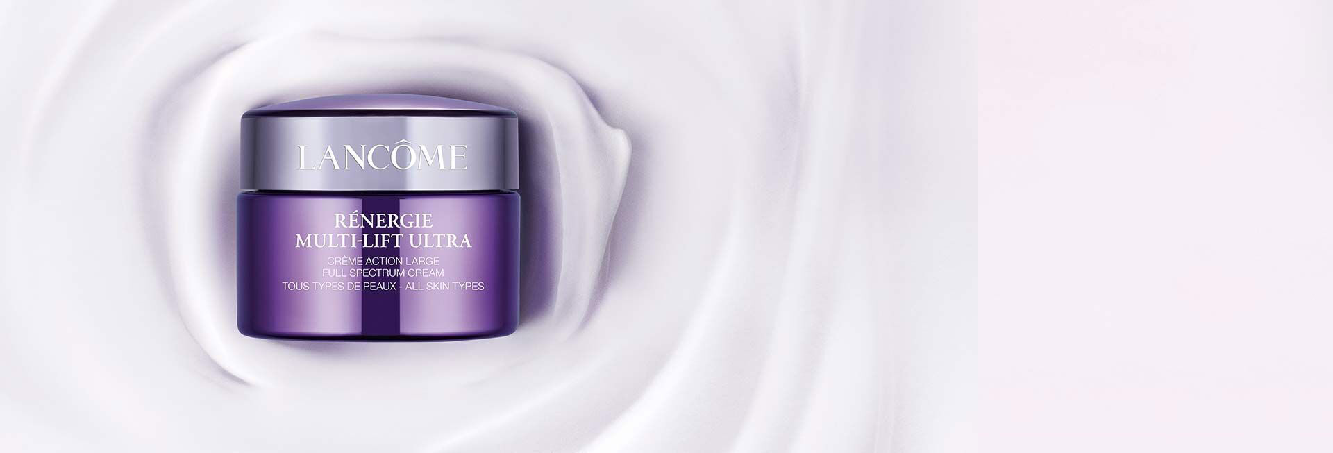 A purple jar of Lancome Renergie Multi-Lift Ultra cream sits on a smooth, swirled background, highlighting its luxurious design.