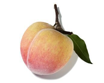 A ripe peach with yellow and pink hues, attached to a small branch with a green leaf.