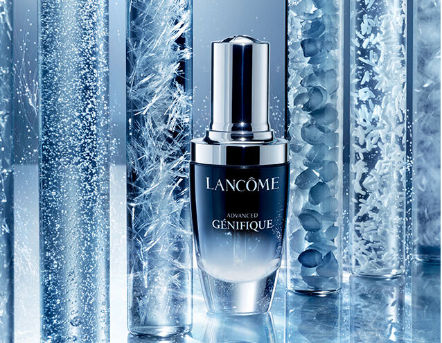 A sleek bottle of Lancome Advanced Genifique serum surrounded by glass tubes filled with various ingredients, showcasing a luxurious skincare theme.