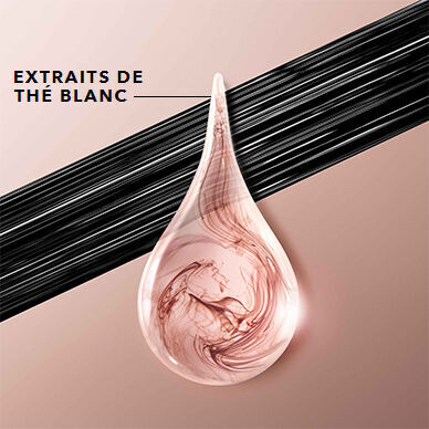 A translucent drop with swirling pink and beige patterns, representing a product containing white tea extracts, set against a smooth, light background with dark lines above.