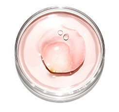 A clear jar containing a light pink gel with a few drops of water on top, resembling a flower petal.